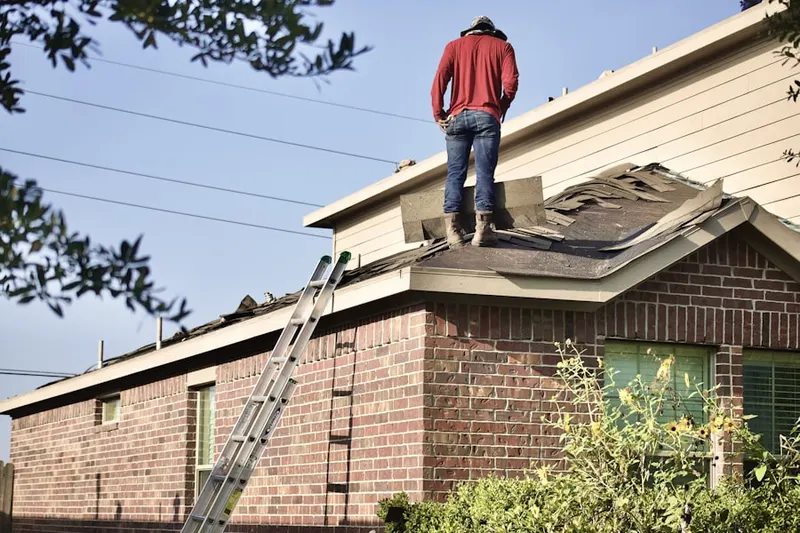 Professional roofer working on a residential roof in Shimerville